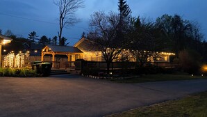 A house with a porch, a covered area, and string lights. - Newly renovated, game room, skiing, sauna, water parks, golf, suites  (Cresco)