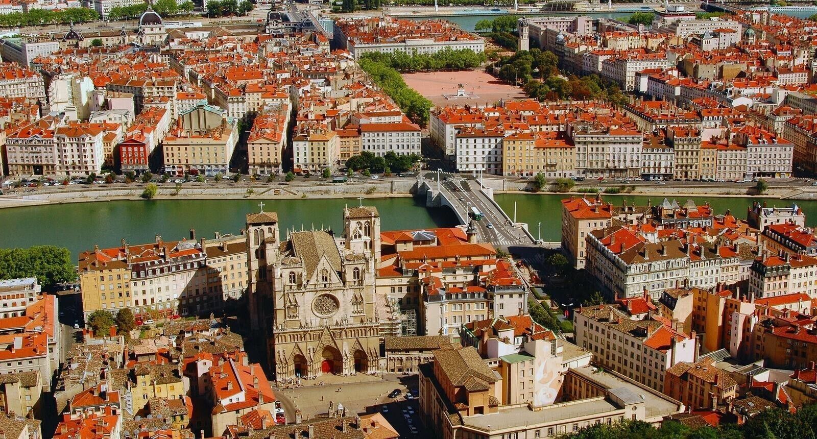 A cityscape with a prominent cathedral, a river, and a bridge.