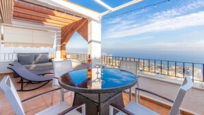 A balcony with a glass table, chairs, a sofa, and a view of the sea. - Casa de la Vista, Best Panoramic View on the Mediterranean (Benitachell)