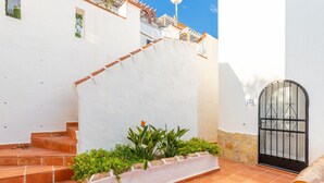 A white building with a black gate, terracotta steps, and a small garden area. - Casa de la Vista, Best Panoramic View on the Mediterranean (Benitachell)