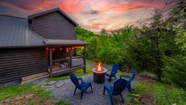 A rustic cabin with a fire pit and outdoor seating. - Family Oasis By Ghosal Luxury Lodging (Sevierville)