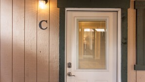 A white door with a glass panel and a letter "C" above it. - The Yellowstone Hideaway Unit C (West Yellowstone)