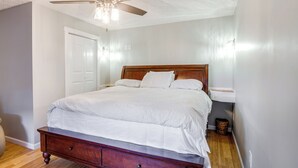 A bedroom with a wooden bed, a ceiling fan, and a nightstand. - Peaceful Russell Springs Home w/ Fire Pit & Pond! (Russell Springs)