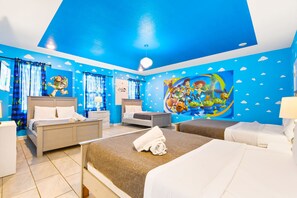 A hotel room with two beds, a large mural, and a blue ceiling.