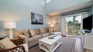 A living room with a sofa, two side tables with lamps, a coffee table, and a TV on a cabinet. - 2 BR/2BA Courtside Villa! Amenity access NOT available Dog Friendly!Tennis Court Views! (Seabrook Island)