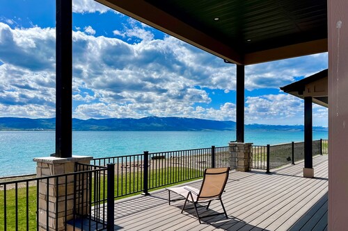 Brand-new lakefront home with private beach, mountain views, fireplace & deck