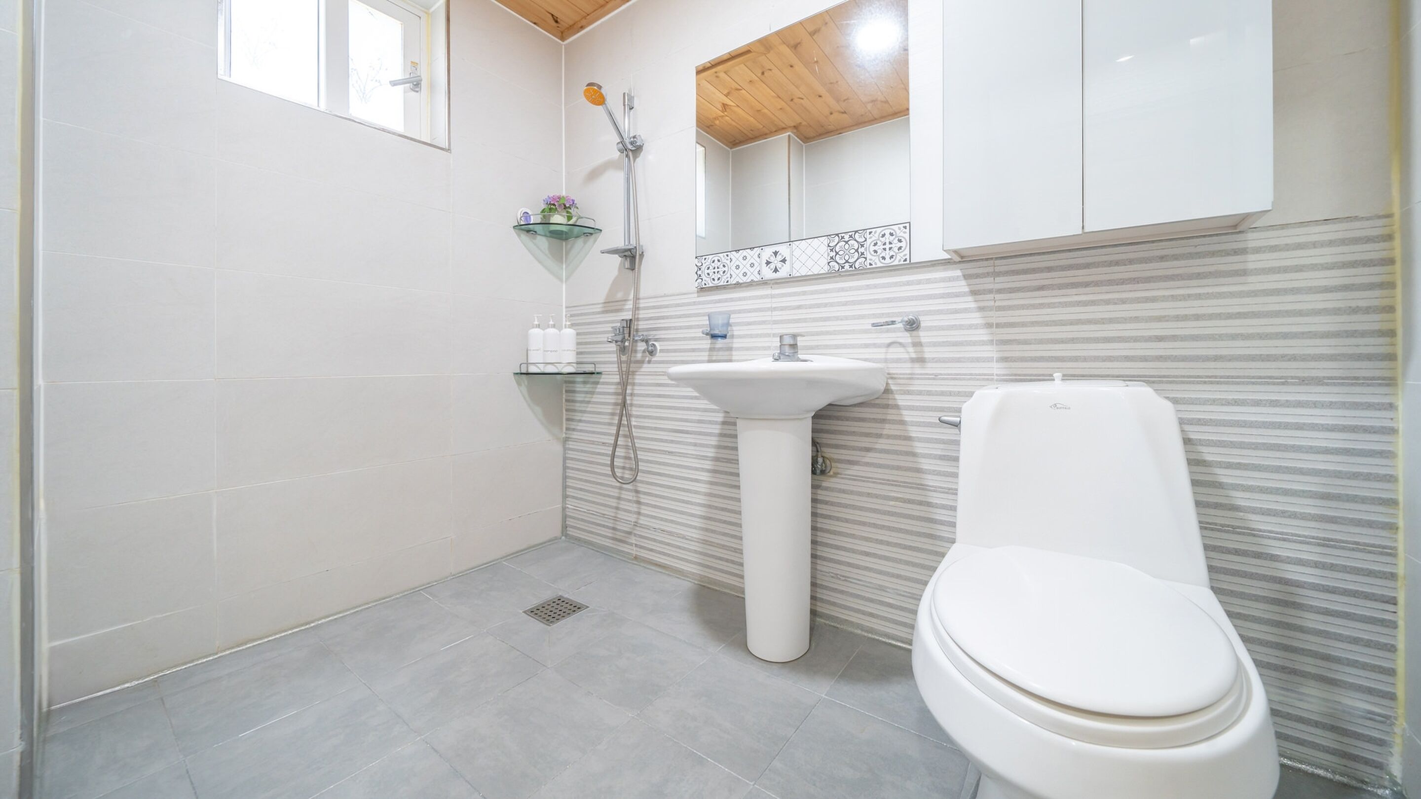 Ein Badezimmer mit Toilette, Waschbecken und Dusche.