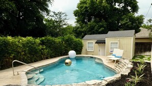 A backyard with a swimming pool, a small deck, and a shed. - New! Chic Cottage Home W/ Backyard Pool - 12 min to the River Walk! (Alamo Heights)
