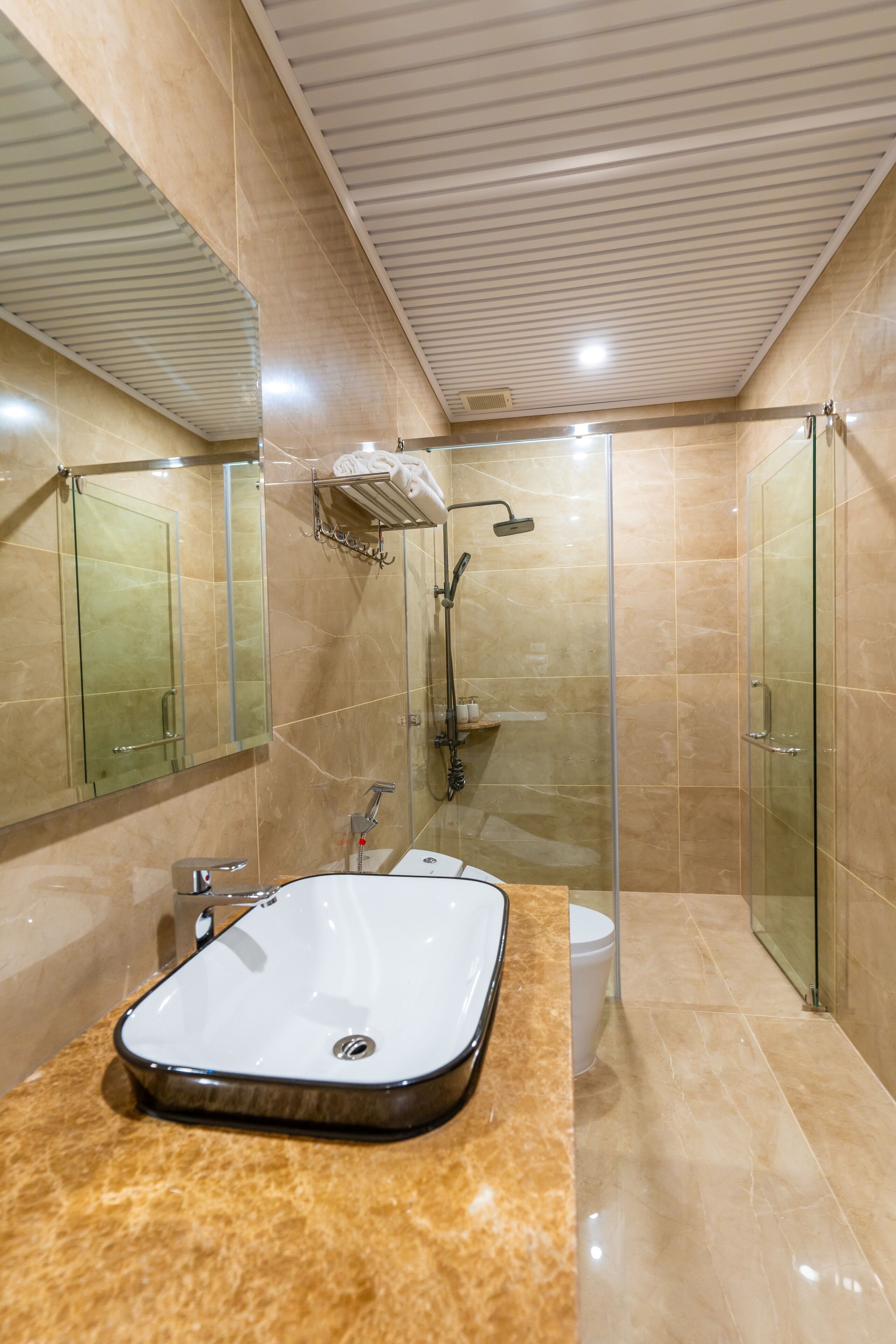 A modern bathroom with a large bathtub, a glass-enclosed shower, and a toilet.