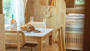 A wooden dining table with a bottle of Mouton Rothschild wine, a basket of bread, and two glasses of wine. - Gapyeong Dalmeong Pool Villa Glamping (Gapyeong)