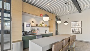 A modern kitchen with a central island, bar stools, pendant lighting, and a view of the city through large windows. - "Faith of Evanston" 180°view, 2BDR +2Bath Urban luxury (Evanston)