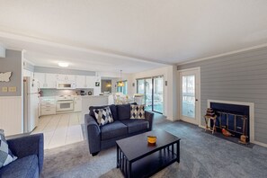 TV, fireplace - Coastal condo with shared pool, balcony, open layout, internet, W/D, & AC (Ocean City)