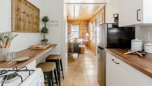 A modern kitchen with wooden countertops, a built-in stove, and a refrigerator.