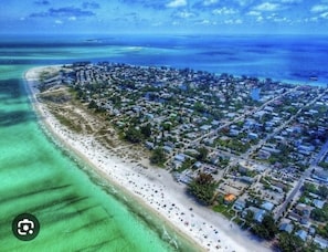 An aerial view of a coastal town with a long sandy beach and dense residential area. - NEW Luxury Getaway Near Beaches! Heated Pool,Game Room,IMG– Limited-Time Offers! (Bradenton)