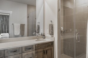 Douche, baignoire à remous, séchoir à cheveux, serviettes fournies