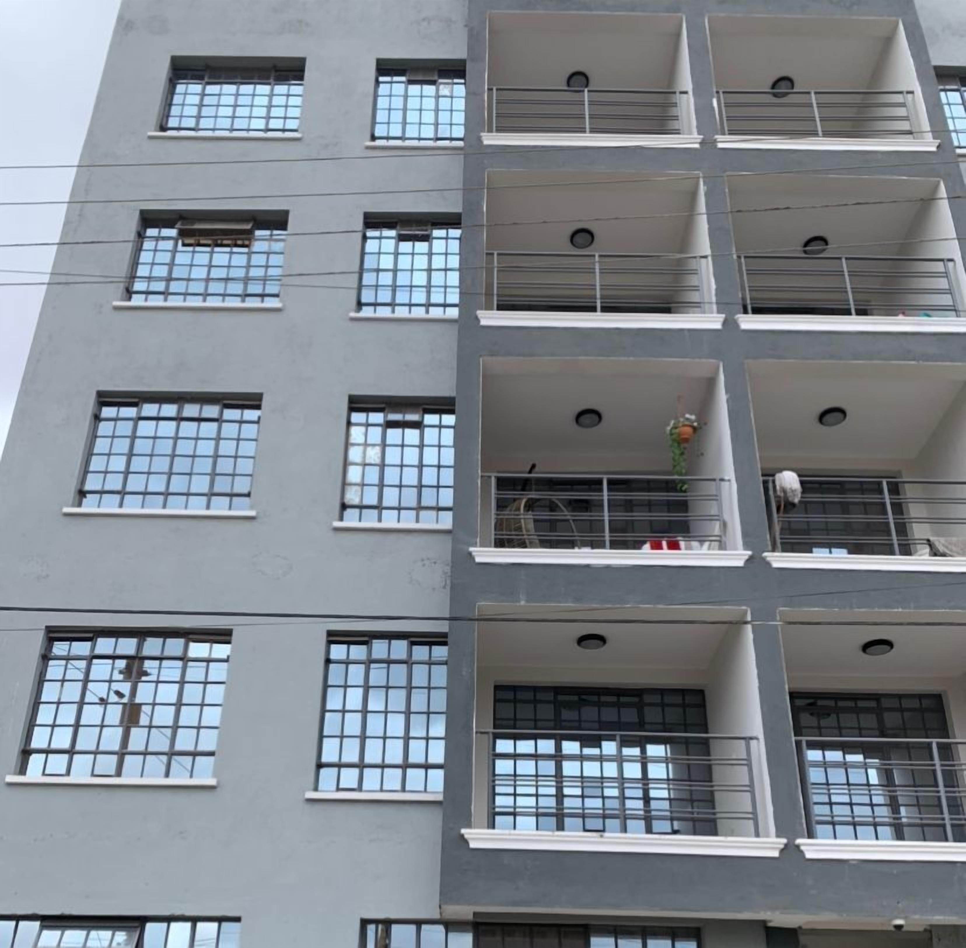 A multi-story building with balconies and windows.