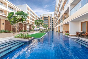 Relax by the pool surrounded by balconies with views of the central pool area.