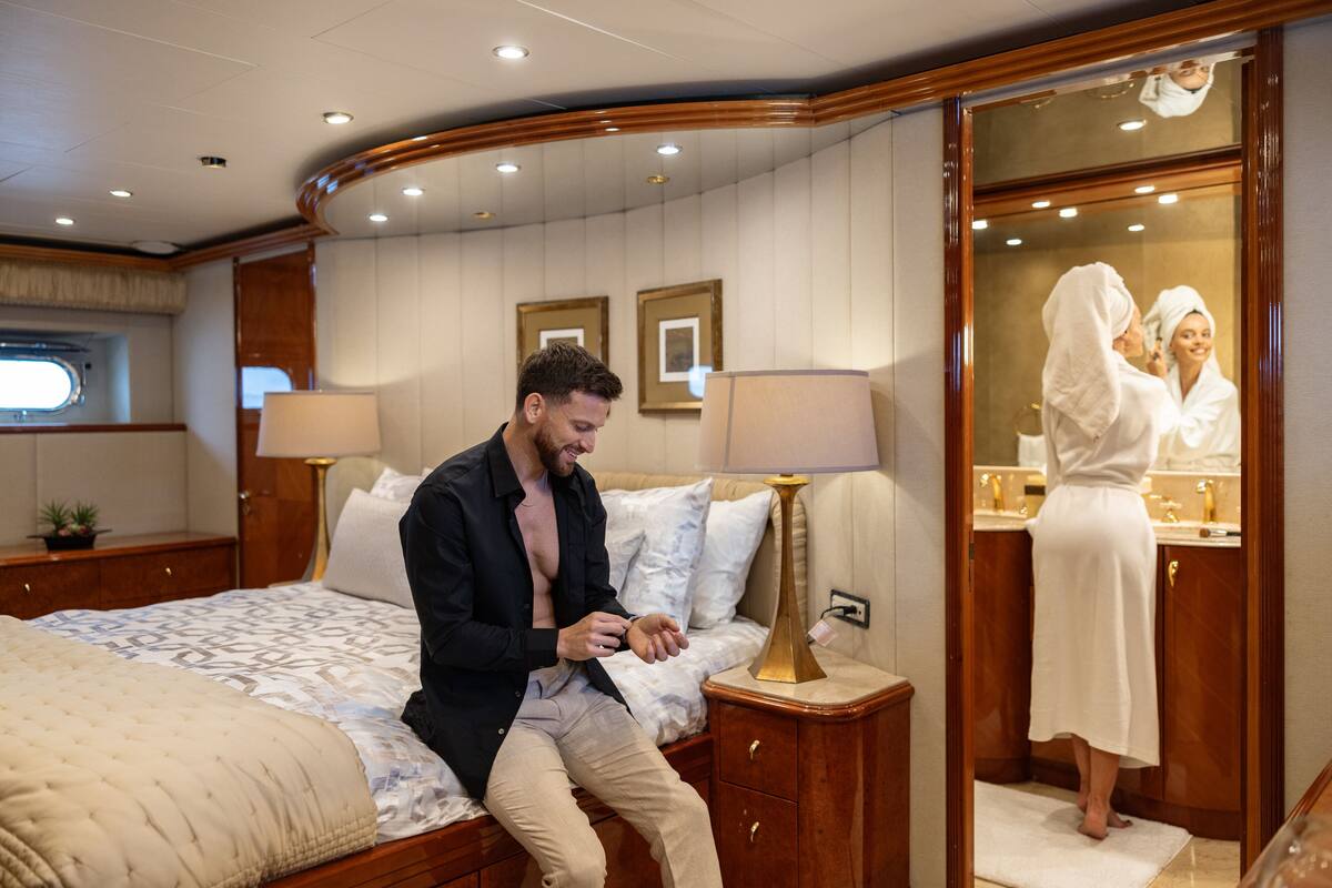 A well-appointed bedroom with a large bed, bedside tables, and a mirror.