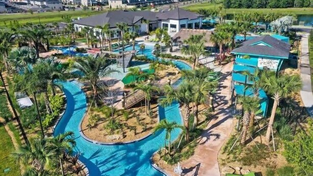 A resort with a large swimming pool, palm trees, and modern buildings. - Family Fun in Near Disney Star Wars, Pool, BBQ (Kissimmee)