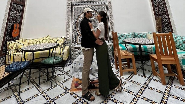 A room with a high, ornate ceiling, a patterned tapestry, and a tiled floor. - Riad Fes Colors & Spa (Fes)