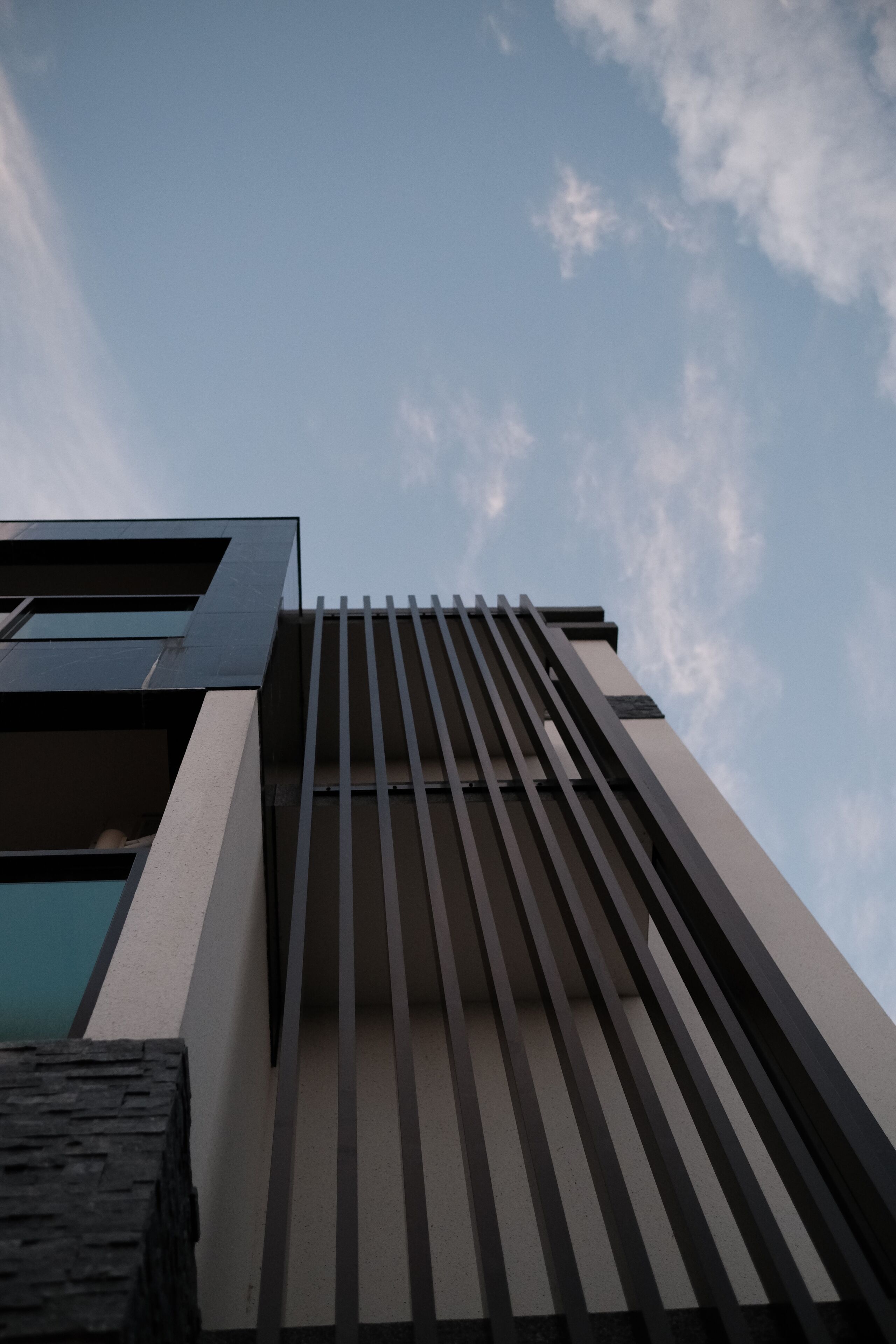 A modern building with a sloped roof and vertical lines.
