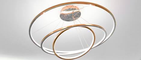 A modern, circular chandelier with multiple rings and a central reflective element.