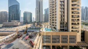 A high-rise building with a rooftop pool, surrounded by other tall buildings in an urban setting. - The Burj Khalifa Collection (Dubai)