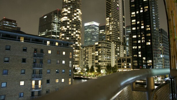 A nighttime cityscape with tall buildings and a bridge. - Meridian Stays Canary Wharf Near O2 Arena (London)