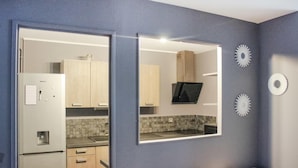 A modern kitchen with wooden cabinets, a built-in microwave, and a tiled backsplash. - Nice apartment in Pontoise with WiFi (Pontoise)