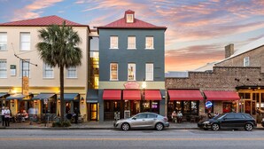 A street view of a building with a red awning and a sign that reads "New York City Hotel." - Luxury French Quarter 1bd Suite w. Parking (Charleston)