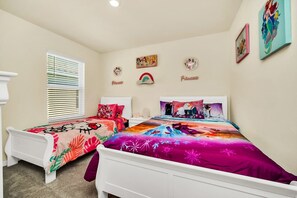 A bedroom with two beds, a window with blinds, and wall decorations including a rainbow and the word 'Princess.' - Luxury 7BR6BA Home with Private Pool and Amenities (Davenport)