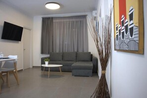 Premium Apartment | Living area | 50-inch Smart TV with digital channels, Netflix, streaming services - Synathens II - Apartments & Studios (Athens)