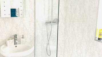 Shower, towels, soap, toilet paper