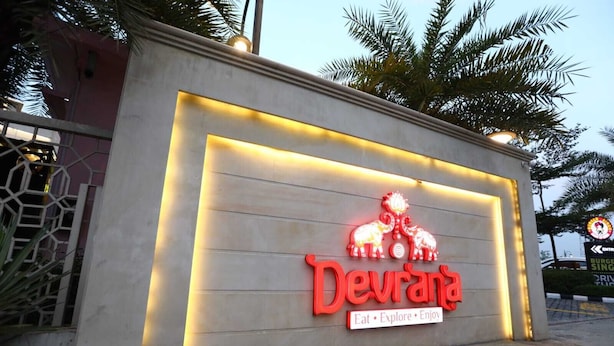 A building with a neon sign reading "Devrana" and a slogan "Eat · Explore · Enjoy". - Devrana (Khatoli)