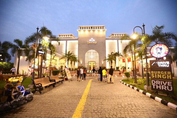 A hotel entrance with a prominent sign for Burger Singh Drive Thru. - Devrana (Khatoli)