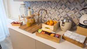 A kitchen counter with a variety of food items and kitchen appliances. - Slow Chic Apartment b&b policlinico (Messina)