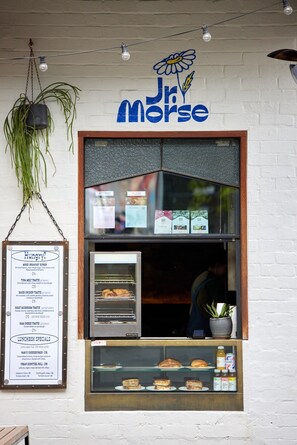 A restaurant named 'Jr. Morse' with a menu board and a display case of baked goods.