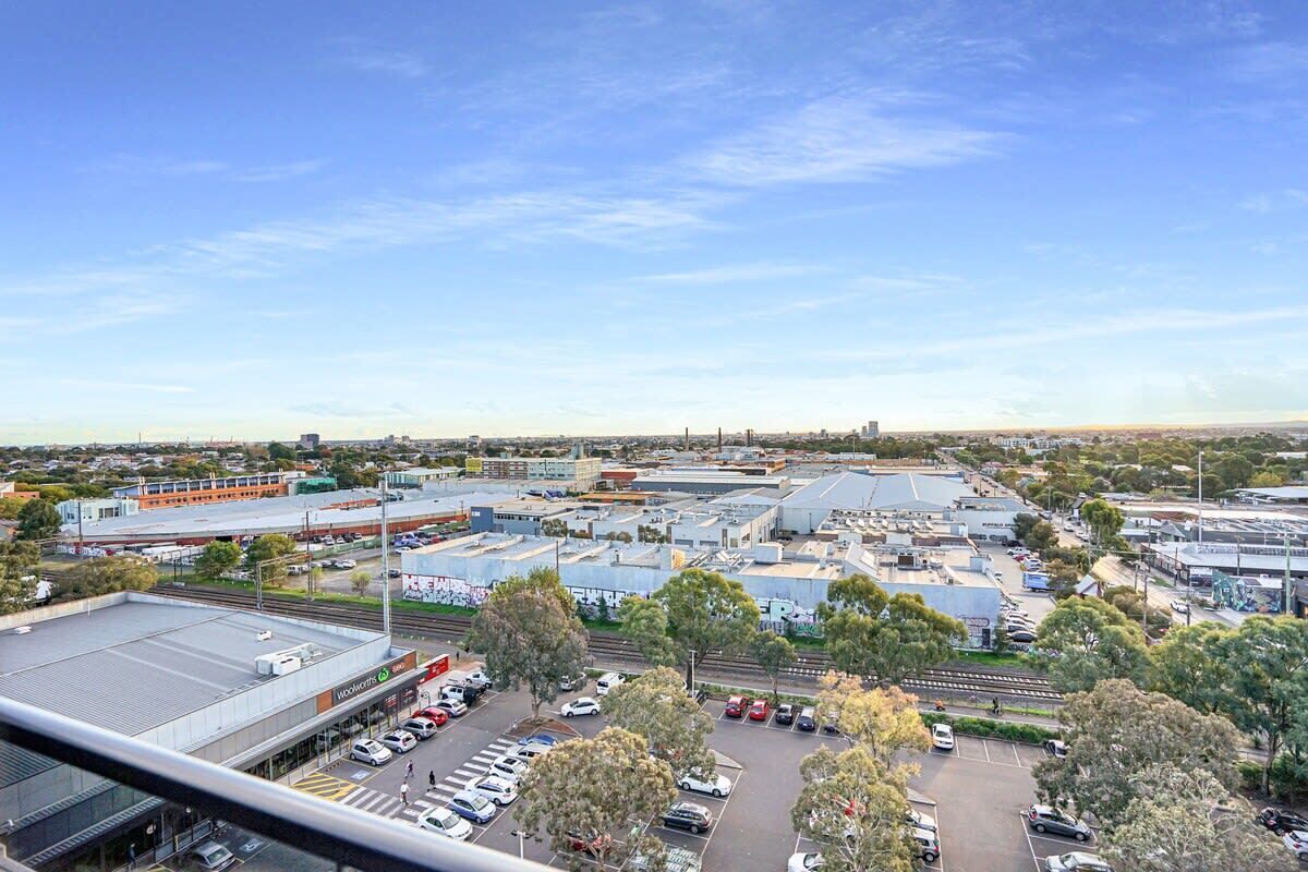 A commercial area with multiple buildings, parking lots, and a clear sky.