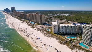 A coastal hotel with multiple high-rise buildings, a sandy beach, and a swimming pool. - Gulf-front retreat with 3 pools, patio, and beach access! (Orange Beach)