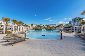 A pool area with lounge chairs and a central water feature. - BVR 05 - Blue Heaven by Liquid Life (Orange Beach)