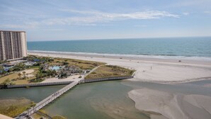 A coastal hotel with a beach view, a pier, and a pool area. - Ocean Creek Kk-14 2 Bedroom Condo by RedAwning (Myrtle Beach)