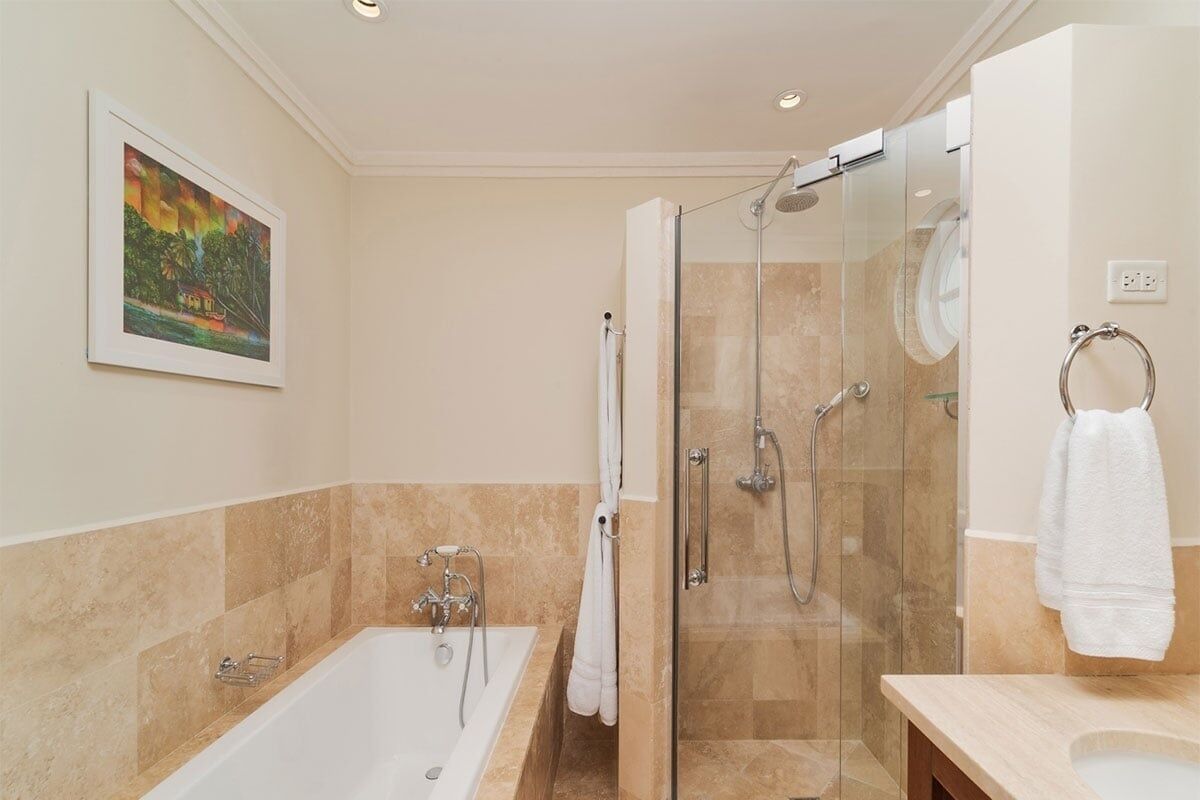 A modern bathroom with a glass-enclosed shower, a bathtub, and a vanity.