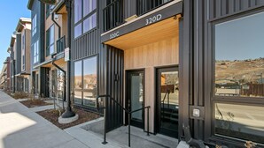 A modern building with large windows and a wooden facade. - Private Rooftop Balcony w/ Hot Tub & Panoramic Mountain Views, Close to Shops (Silverthorne)