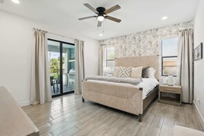 A bedroom with a bed, nightstand, and ceiling fan. - Golf Course Views, Private Pool & Pet-Friendly (Bonita Springs)