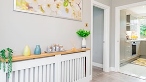 A modern kitchen with grey cabinets, a wooden countertop, and a large window. - Stunning Place near Windsor & Heathrow, 3BR House (Burnham)