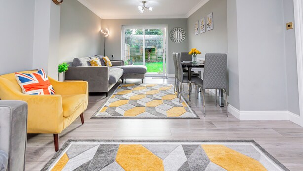 A modern living room with a sofa, armchair, and dining area. - Stunning Place near Windsor & Heathrow, 3BR House (Burnham)