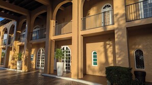 A building with multiple balconies, large windows, and potted plants. - Marina Fish- Boat and Relax in this Paradise newly remodeled in Naples, Florida! (Naples)