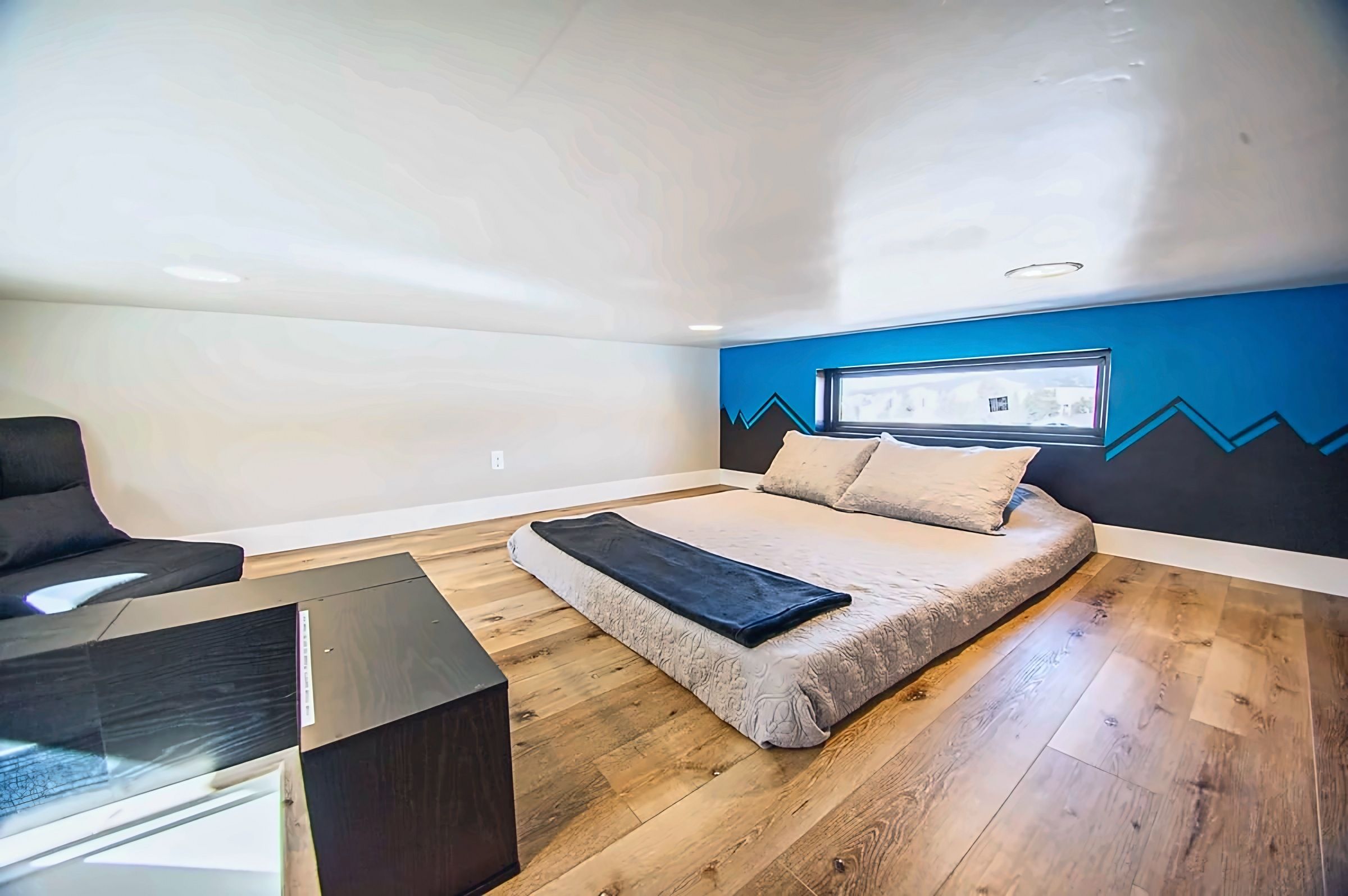 【Loft Bed】Wooden ladder to the sleeping loft — confirmed safe for guests, overhead access point visible.