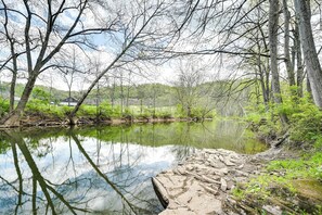 A serene riverside scene with trees and a clear reflection in the water. - Cozy Huntingdon Escape: 19 Mi to Penn State Univ! (Huntingdon)
