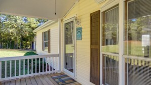 A covered porch with a white railing, a welcome sign, and a door with a window. - Prosperity Vacation Rental ~ 1 Mi to Lake Murray! (Prosperity)